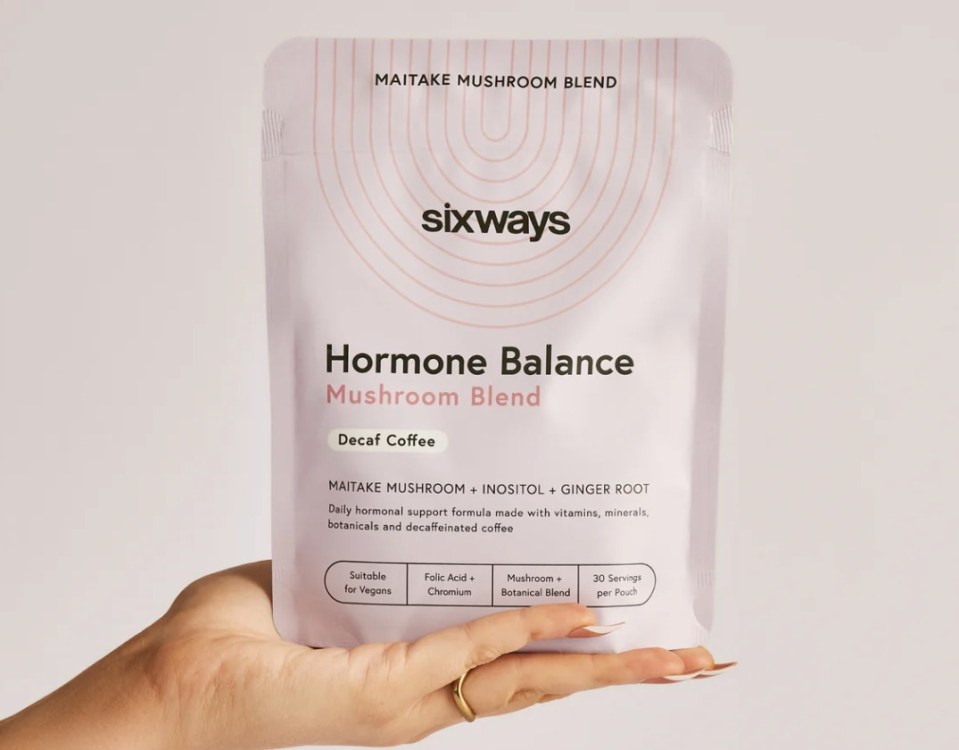 Hand holding a pouch of Sixways Hormone Balance decaf coffee blend.