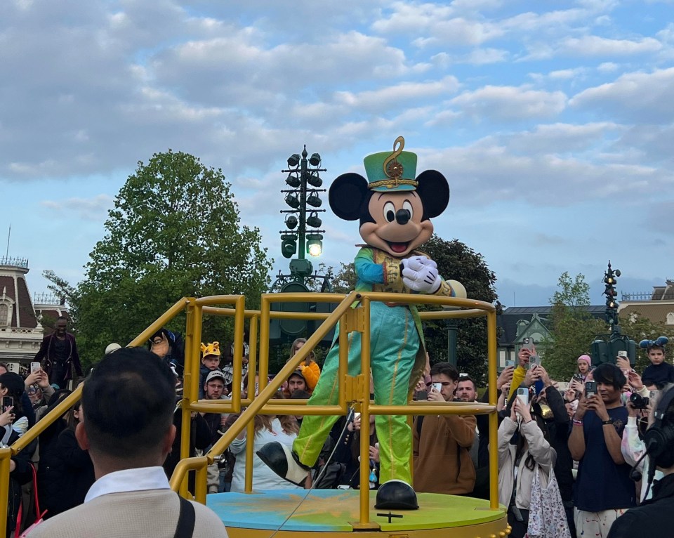 Mickey Mouse in a conductor's outfit at Disneyland Paris Music Festival.