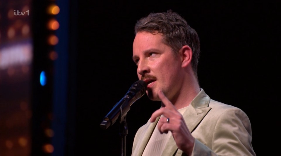 Man singing into a microphone.