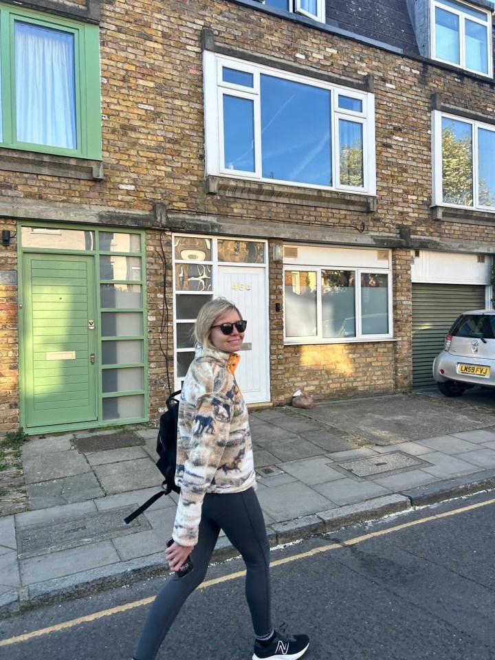 Woman walking down a residential street.