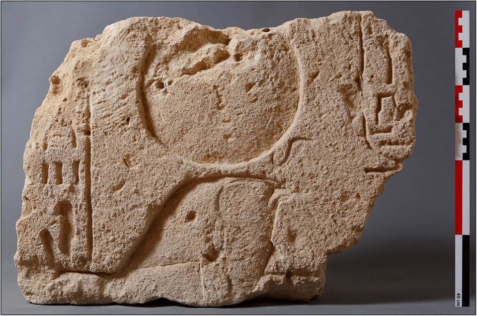 Stone fragment with carved markings from Kom el-Nugus, Egypt.