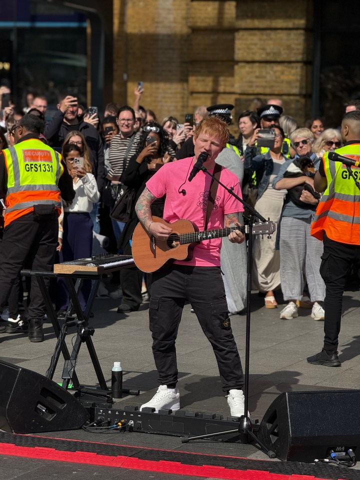 Ed Sheeran performing at King's Cross station.