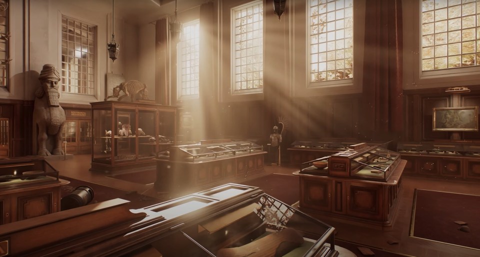 Sunbeams illuminate a museum's interior filled with artifacts in display cases.
