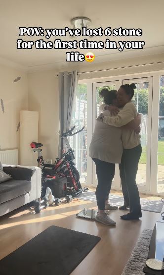 Two women hugging after one has lost six stone.