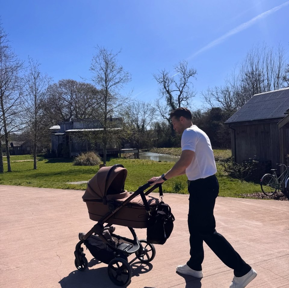 Man pushing a baby stroller.
