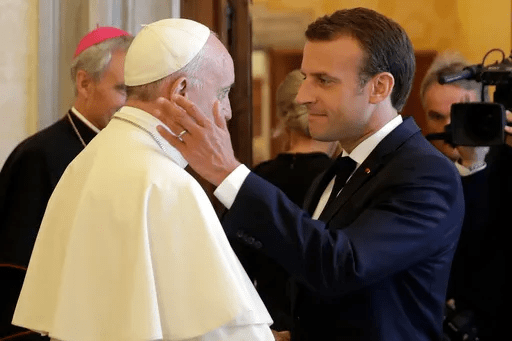 Emmanuel Macron greeting Pope Francis.