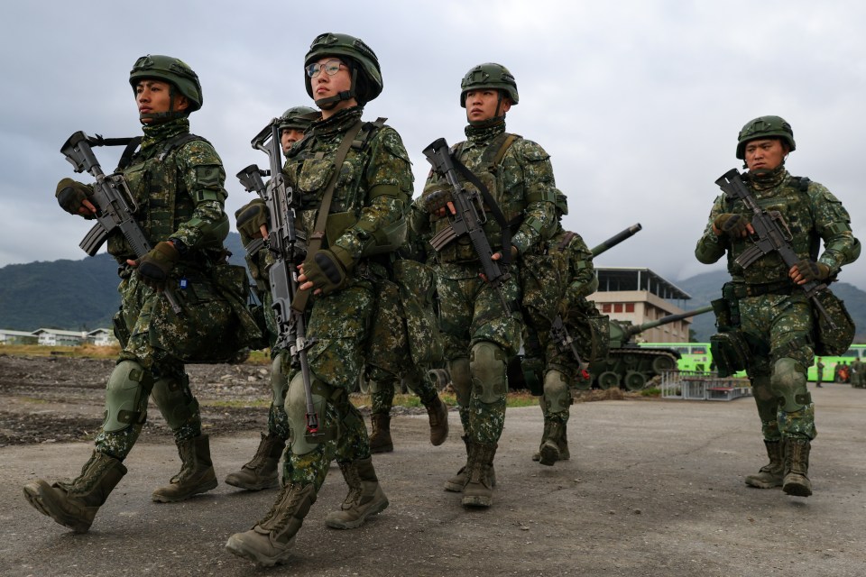 Soldiers carrying rifles.