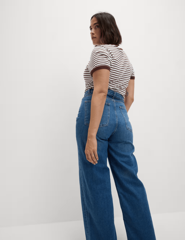 Woman in brown and white striped shirt and blue jeans.