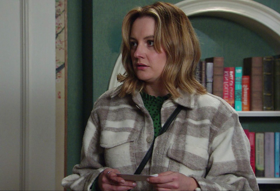 Ella from Emmerdale looking at a photograph.