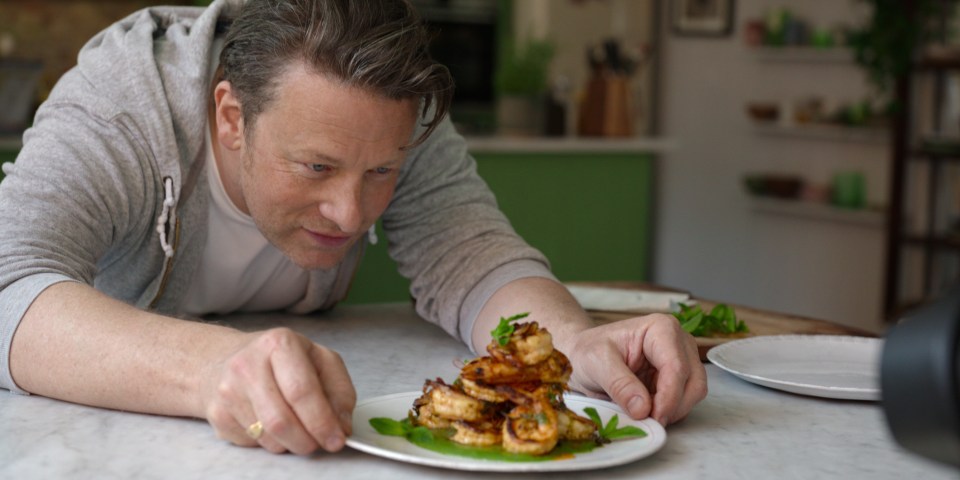 Jamie Oliver preparing a plate of shrimp for Chef's Table: Legends.