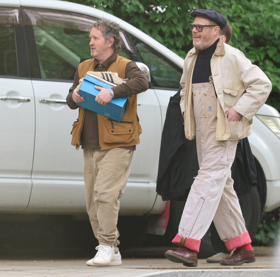 Liam and Noel Gallagher walking together.