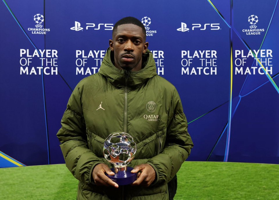 Ousmane Dembele holding a Champions League Player of the Match award.