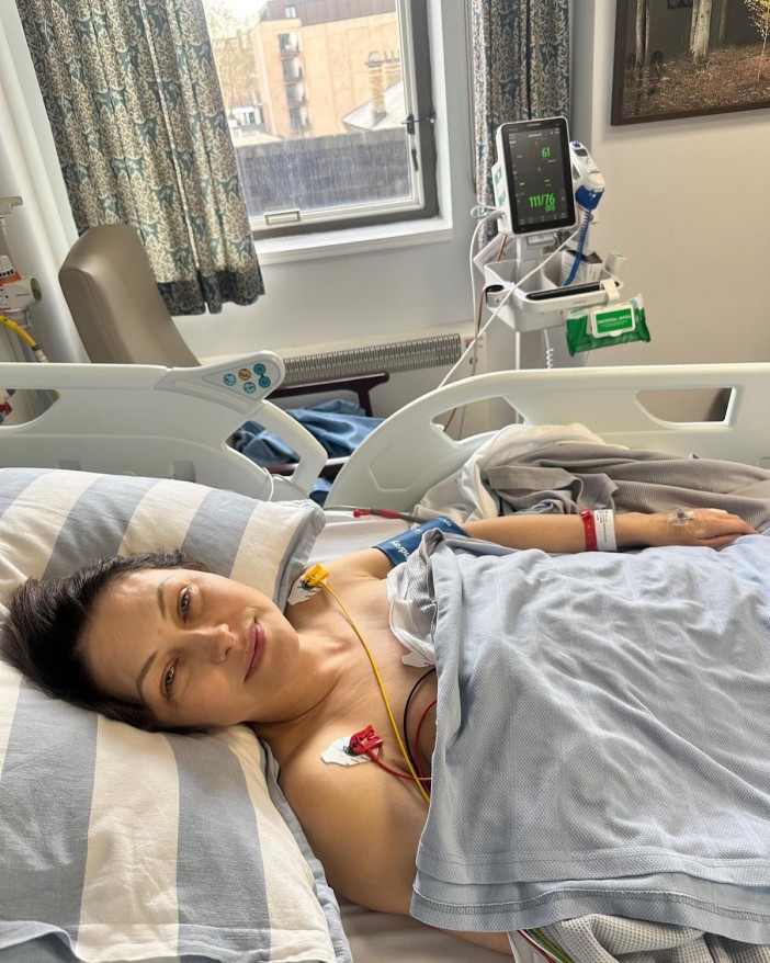 Woman in hospital bed recovering from heart surgery.