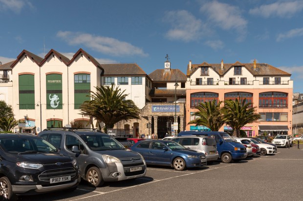 Cars parked in a lot near the Wharfside Shopping Centre in Penzance, Cornwall.