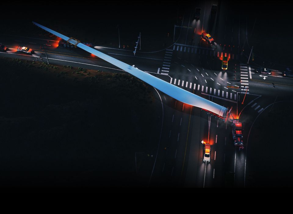Illustration of a large wind turbine blade being transported on a truck at night.