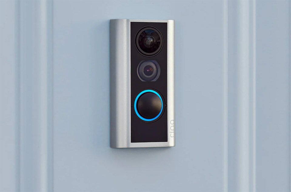 Ring doorbell mounted on a light blue wall.