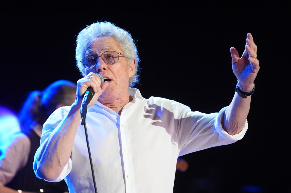 Roger Daltrey singing on stage.