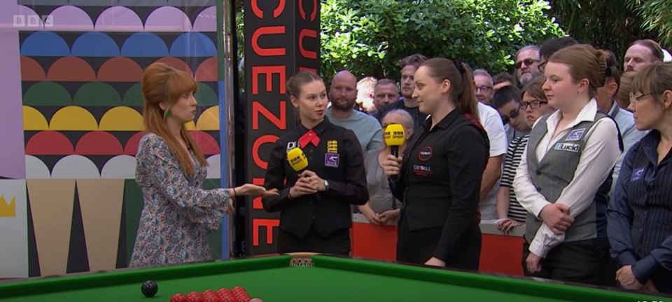 A BBC reporter interviews two female snooker players.