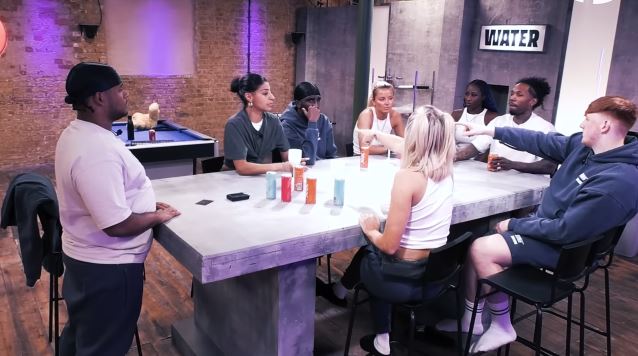 The Sidemen sitting around a table.