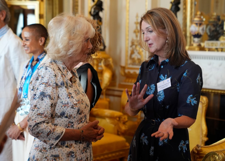 Queen Camilla speaking with Victoria Derbyshire at a Buckingham Palace reception.