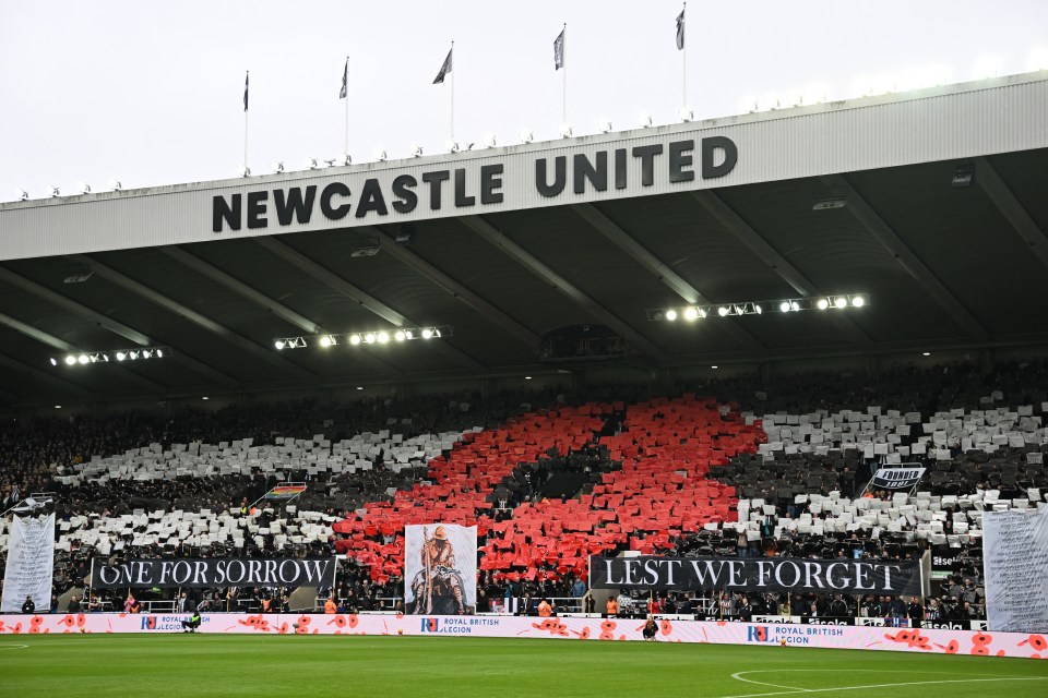 Newcastle United fans holding signs in remembrance at St. James' Park.