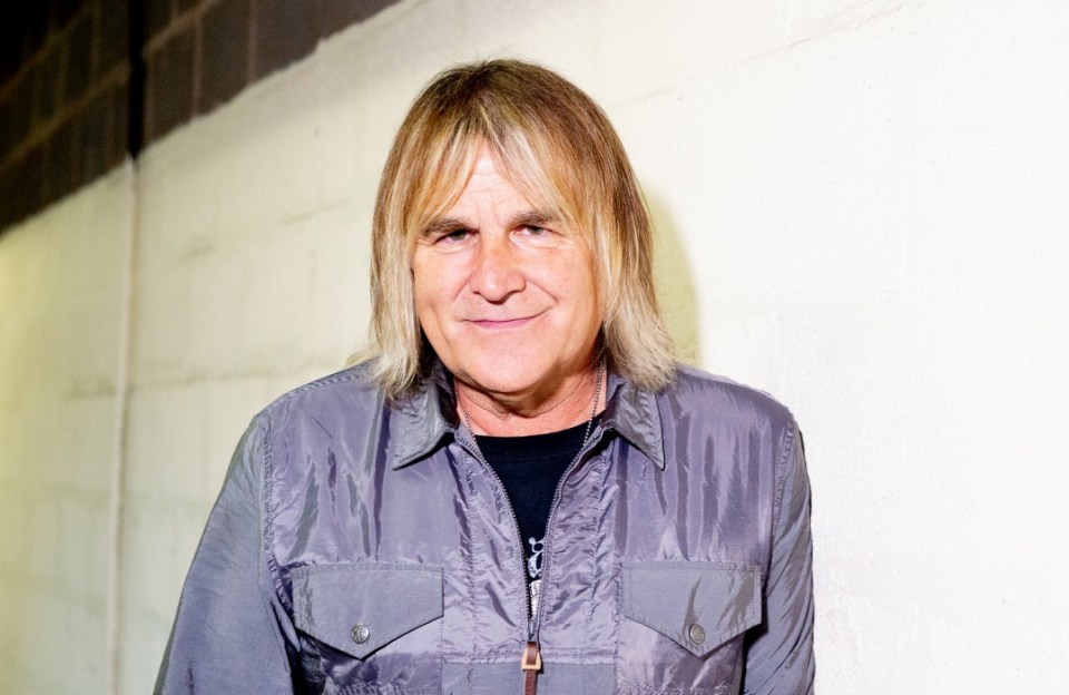 MANCHESTER, ENGLAND - JULY 04: (EXCLUSIVE COVERAGE) Mike Peters of The Alarm poses backstage following an in store session to celebrate their new album 'Sigma' at HMV Manchester on July 04, 2019 in Manchester, England. (Photo by Shirlaine Forrest/WireImage)