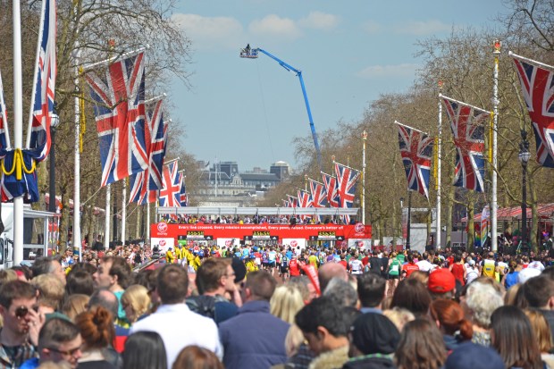 Finish line of the London Marathon with runners and spectators.