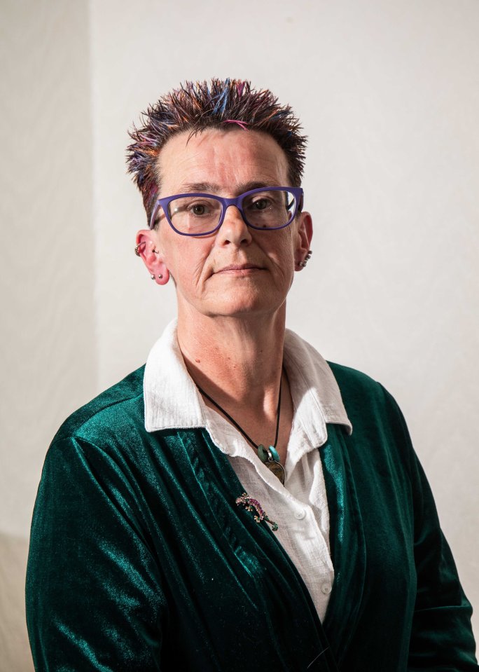 Portrait of a woman wearing glasses and a green velvet jacket.