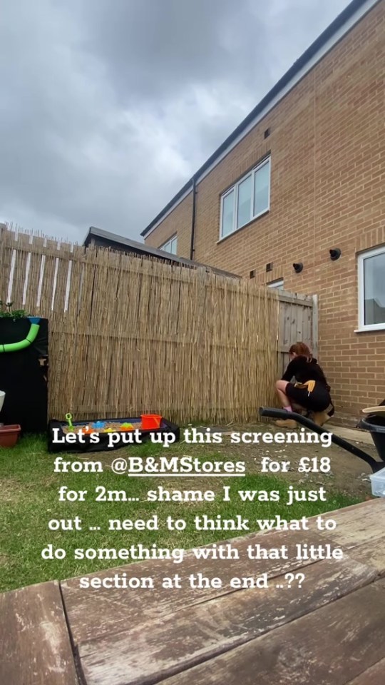 Person installing bamboo screening in their backyard.