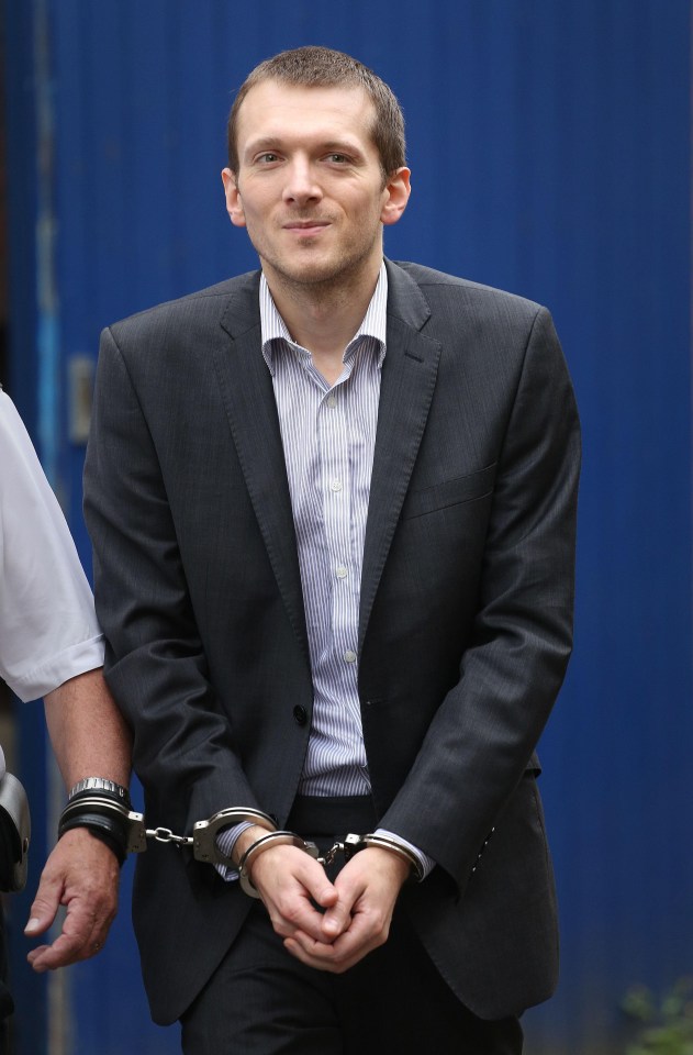 A man in a suit and handcuffs.