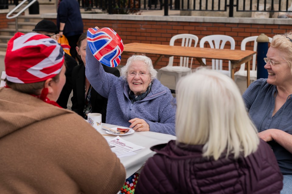 People celebrating VE Day at a street party in Lytham, England.