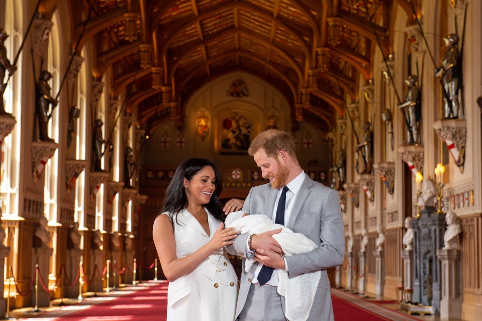 Prince Harry and Meghan Markle holding their newborn baby son at Windsor Castle.