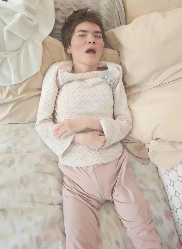 Two photos of a young woman; one smiling and looking at the camera, the other lying in bed.