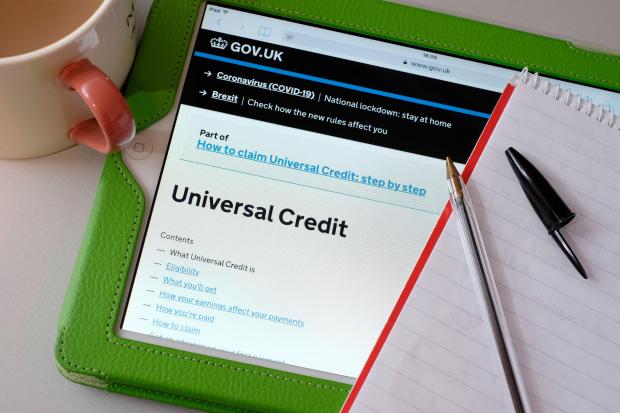 Tablet displaying the UK government website's Universal Credit page.