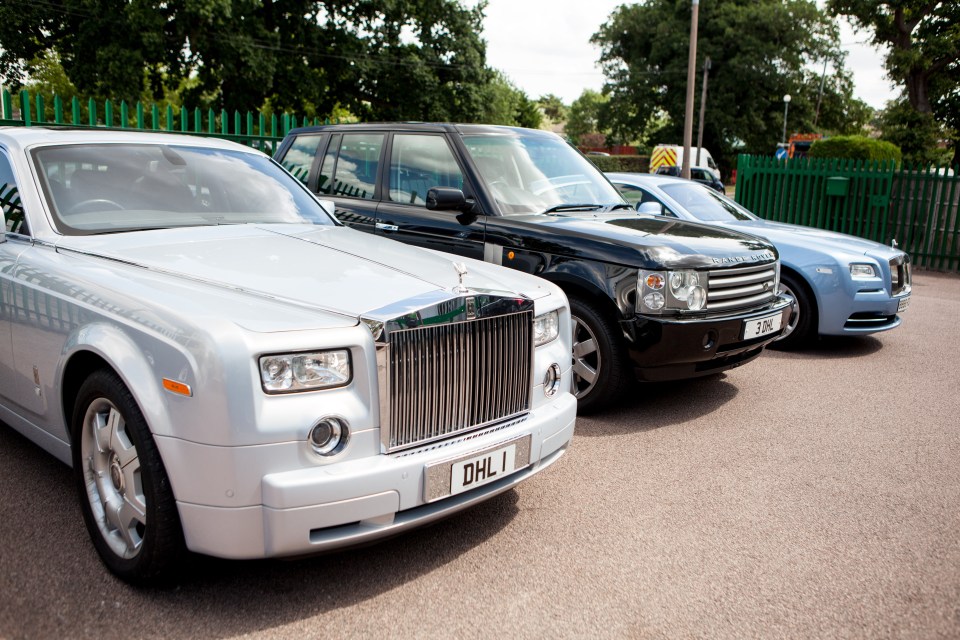 Three luxury cars parked in a row.