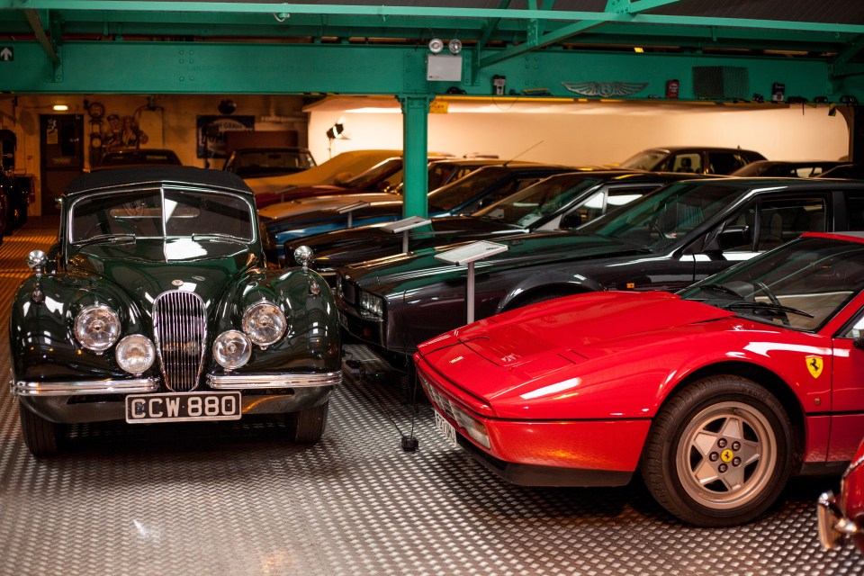 A collection of classic cars in a garage.