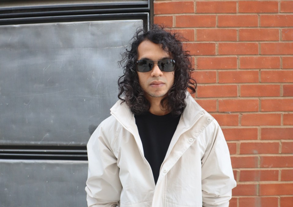 Portrait of Aditya Ashok, also known as OX7GEN, wearing sunglasses and a cream-colored jacket.