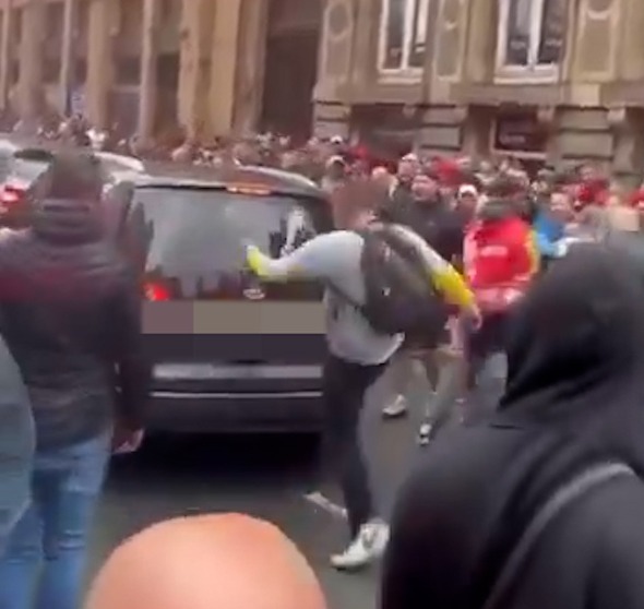A car driving into a crowd of people.
