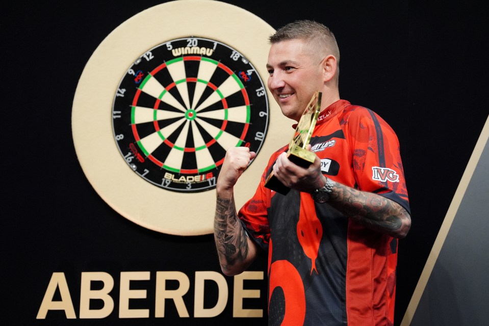 Nathan Aspinall celebrates with the trophy after winning the final against Chris Dobey on night fifteen of the BetMGM Premier League at P&J Live, Aberdeen. Picture date: Thursday May 15, 2025. PA Photo. See PA story DARTS Aberdeen. Photo credit should read: Andrew Milligan/PA Wire. RESTRICTIONS: Use subject to restrictions. Editorial use only, no commercial use without prior consent from rights holder.