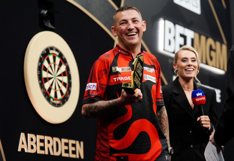 Nathan Aspinall celebrates with the trophy after winning the final against Chris Dobey on night fifteen of the BetMGM Premier League at P&J Live, Aberdeen. Picture date: Thursday May 15, 2025. PA Photo. See PA story DARTS Aberdeen. Photo credit should read: Andrew Milligan/PA Wire. RESTRICTIONS: Use subject to restrictions. Editorial use only, no commercial use without prior consent from rights holder.