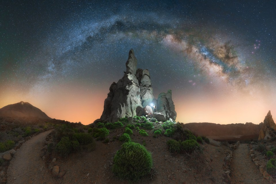 Milky Way arch over Los Roques de García rock formations in Teide National Park, Tenerife.