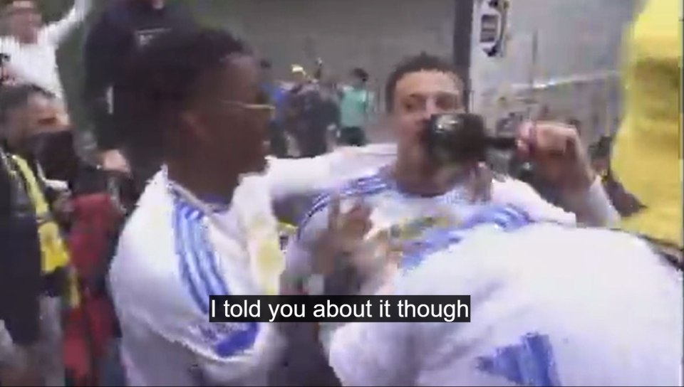 Two men in white shirts celebrating.