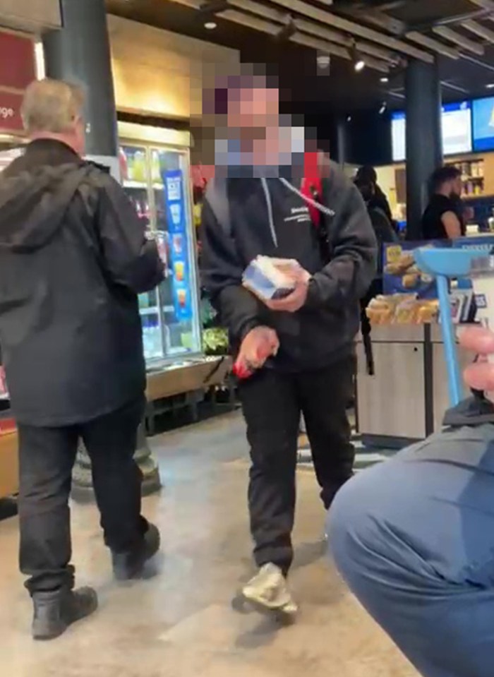 Person holding a package in a store.