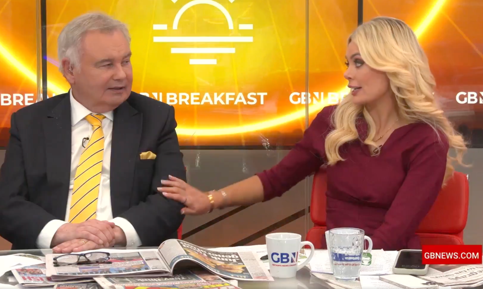 Screenshot of two news presenters sitting at a table during a broadcast.