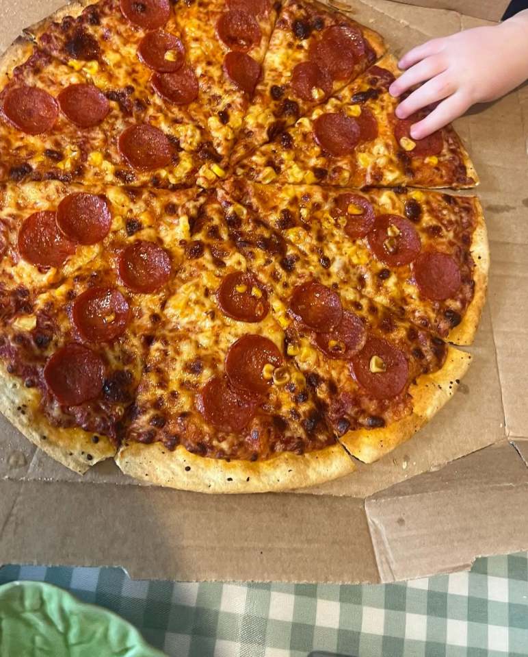 Pepperoni and corn pizza in a box.