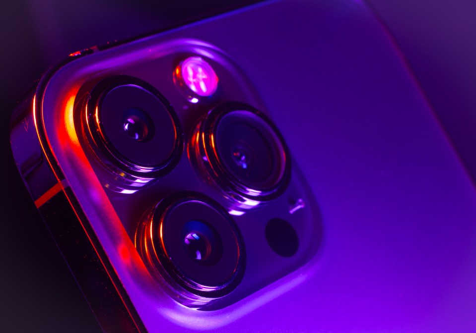 Close-up photo illustration of an iPhone's camera module.