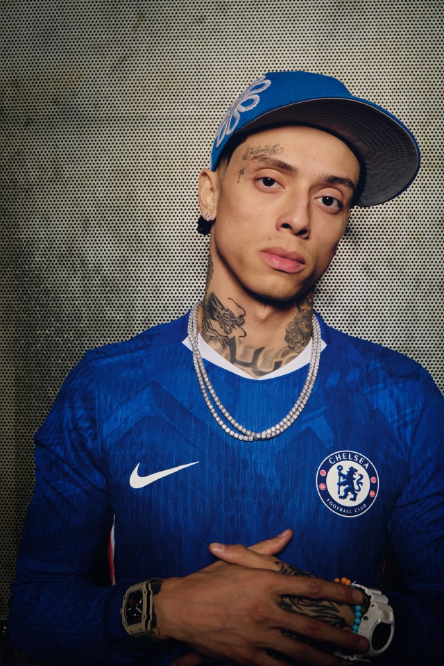 Central Cee posing in a Chelsea Football Club jersey.