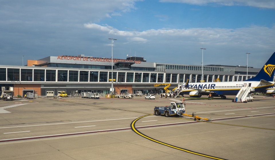 Charleroi Brussels South Airport terminal with a Ryanair plane at the gate.