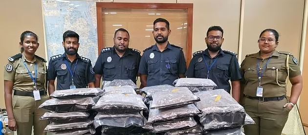 Sri Lankan police officers with seized drugs.