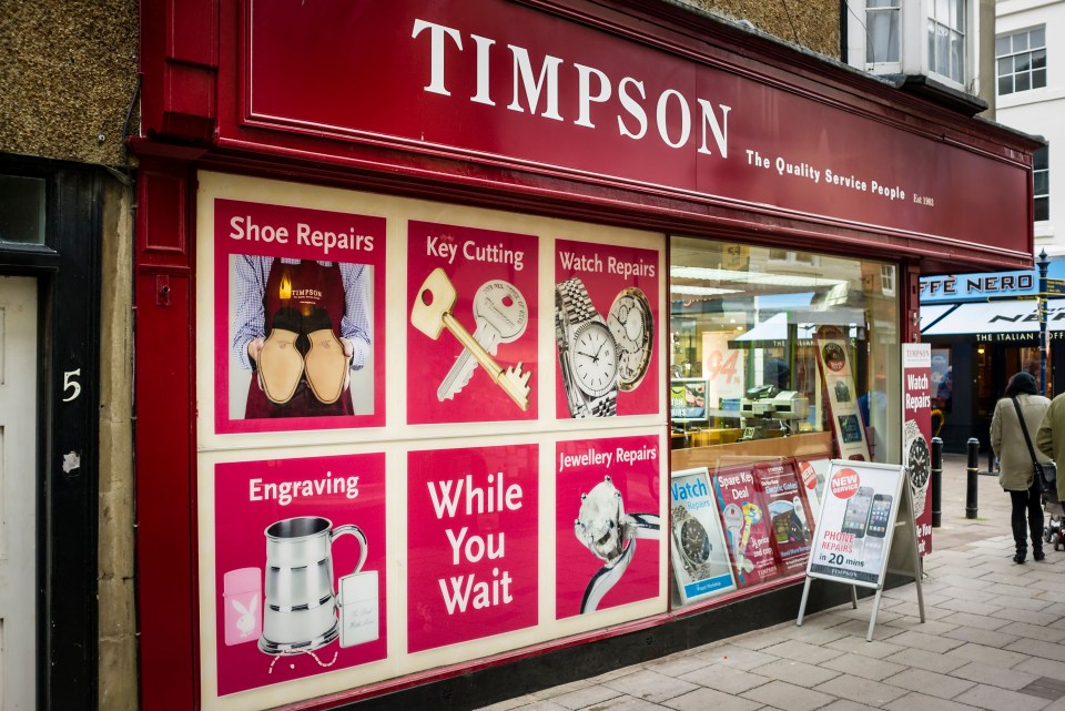 Timpson shop window display advertising shoe, key, watch, and jewellery repairs, engraving, and phone repairs.